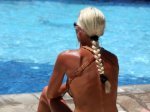 girl with dark tanned back at the pool