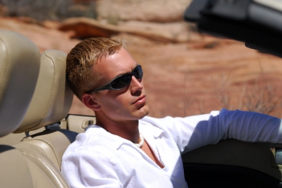 Man driving convertible with sunglasses