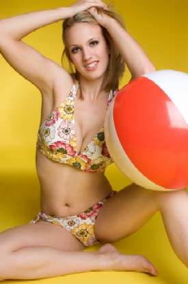 girls floral bathing suit with ball and yellow background