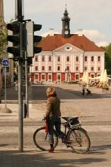 lady on bike at traffic light in shade