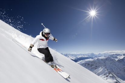 FEMALE SKIER WITH SUN