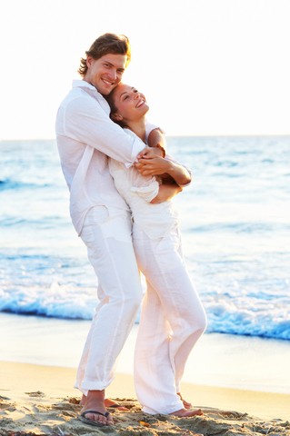 Couple in white clothing at the beach