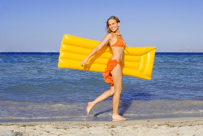 Girl running in orange bathing suit on the beach Home Page photo