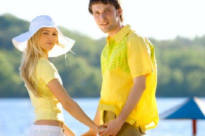 girl and boy in yellow shirts holding hands