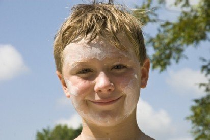 boy with sunscreen all over his face