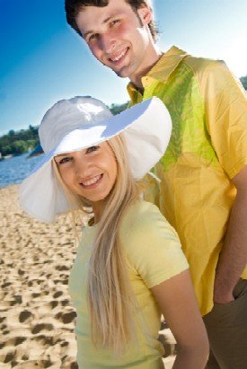 spf clothing boy and girl in yellow shirts at the beach with white hat