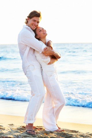 Couple in white clothing at the beach